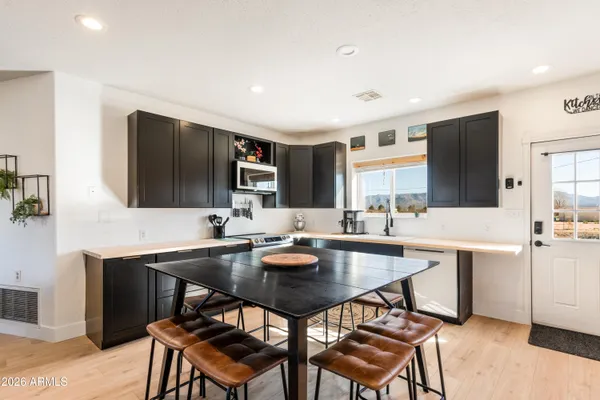 a kitchen with a table and chairs in it