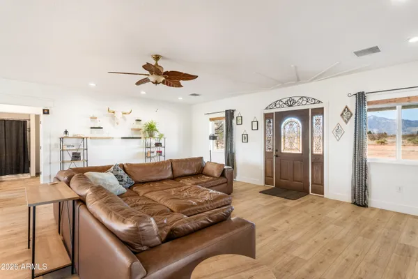 a living room with furniture ceiling fan and a rug