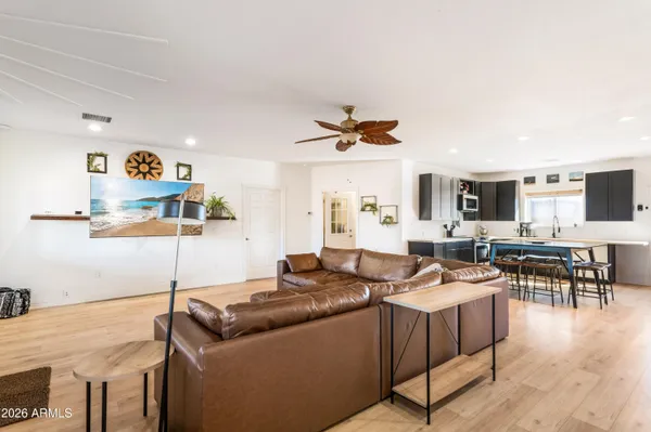 a living room with furniture and a wooden floor