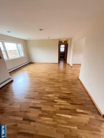 a view of a room with wooden floor