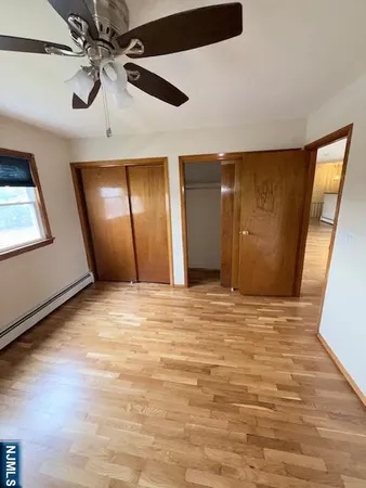 a view of an empty room with a ceiling fan