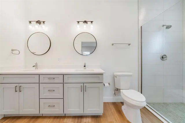 a bathroom with a toilet a sink a mirror and vanity