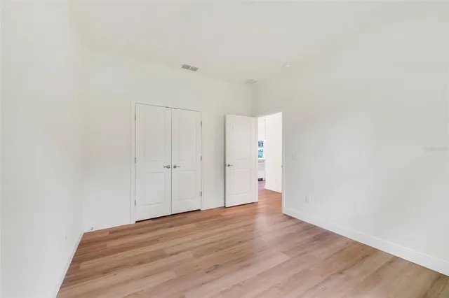 a view of a room with wooden floor