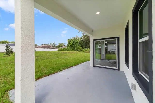 a view of a house with backyard and porch