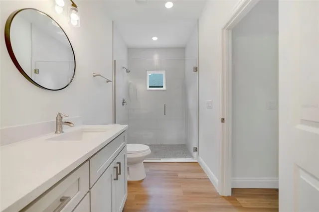 a bathroom with a sink a toilet and a mirror