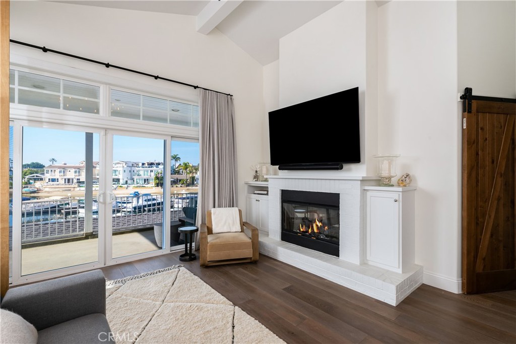 56 Balboa Coves Newport Beach, CA 92663 - Photo 18 of 34 Fireplace in Primary with Balcony Overlooking the Water
