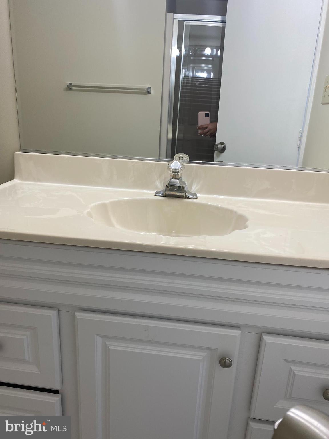200 Chesterfield Lane, Unit 203 Stafford, VA 22556 - Photo 12 of 27 a bathroom with a sink and a mirror