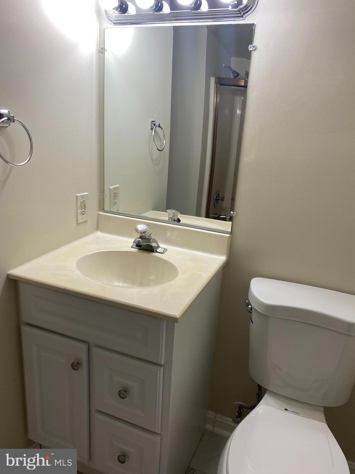200 Chesterfield Lane, Unit 203 Stafford, VA 22556 - Photo 13 of 27 a bathroom with a toilet sink and mirror