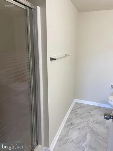 a white toilet sitting next to a bath tub