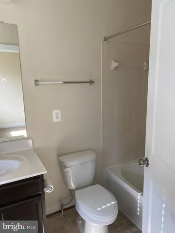 a white toilet sitting next to a shower