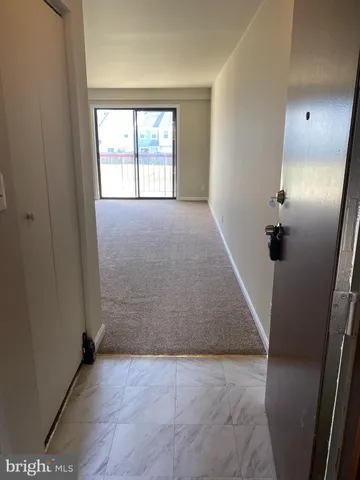 a view of a chandelier fan and refrigerator