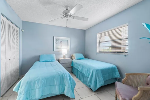 a bedroom with two beds and a window