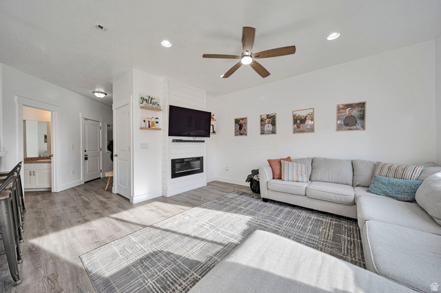 11730 South Shadow Lane Draper, UT 84020 - Photo 6 of 24 Living area featuring light wood-type flooring, a fireplace, ceiling fan, and recessed lighting
