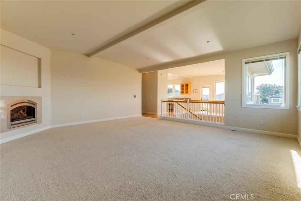 305 Ivar Street Cambria, CA 93428 - Photo 15 of 69 an empty room with fireplace and windows