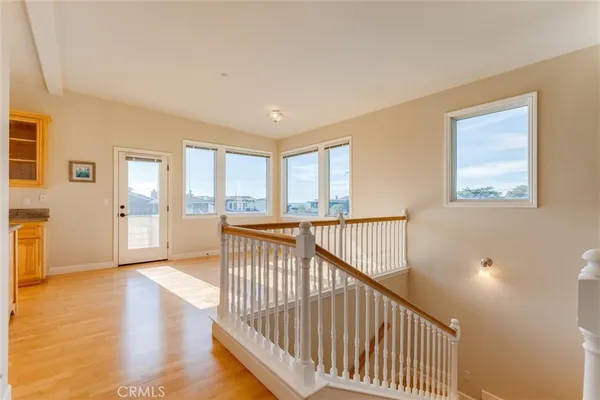 a kitchen with stainless steel appliances granite countertop a stove and a view of living room with a large window
