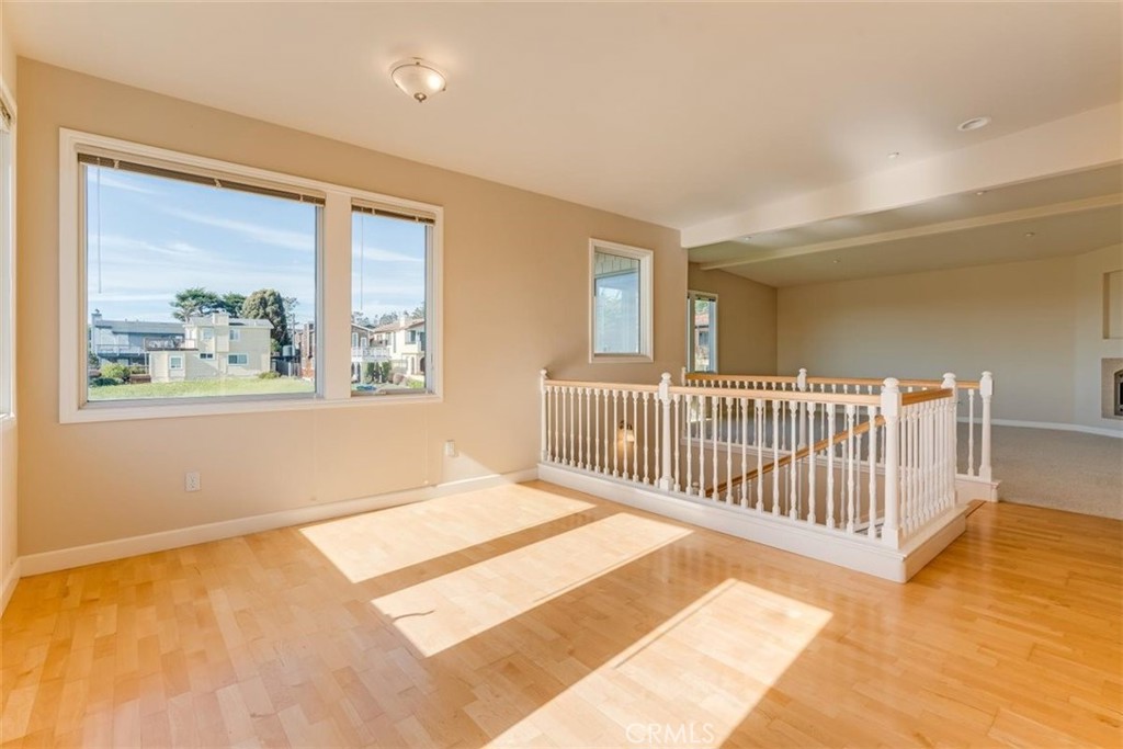 305 Ivar Street Cambria, CA 93428 - Photo 19 of 69 a view of a big room with wooden floor and windows