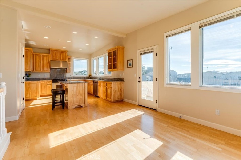305 Ivar Street Cambria, CA 93428 - Photo 21 of 69 a kitchen with stainless steel appliances granite countertop a stove and a view of living room with a large window