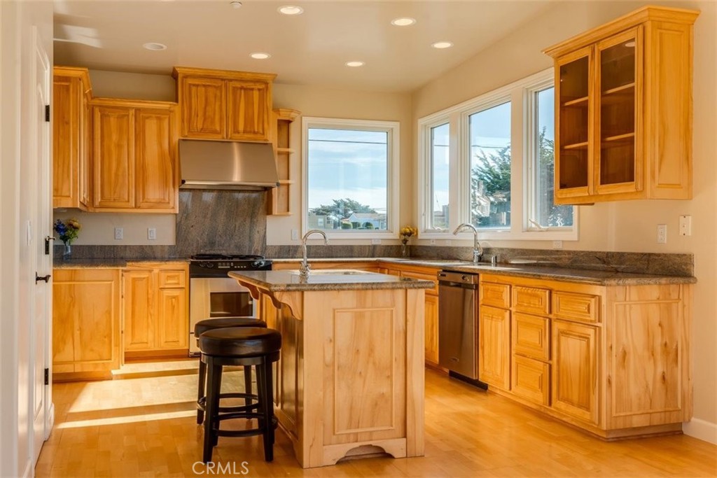 305 Ivar Street Cambria, CA 93428 - Photo 22 of 69 a kitchen with stainless steel appliances granite countertop a stove and a refrigerator