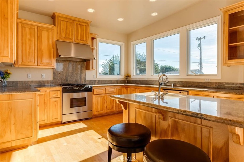 305 Ivar Street Cambria, CA 93428 - Photo 23 of 69 a kitchen with a stove a sink and a refrigerator