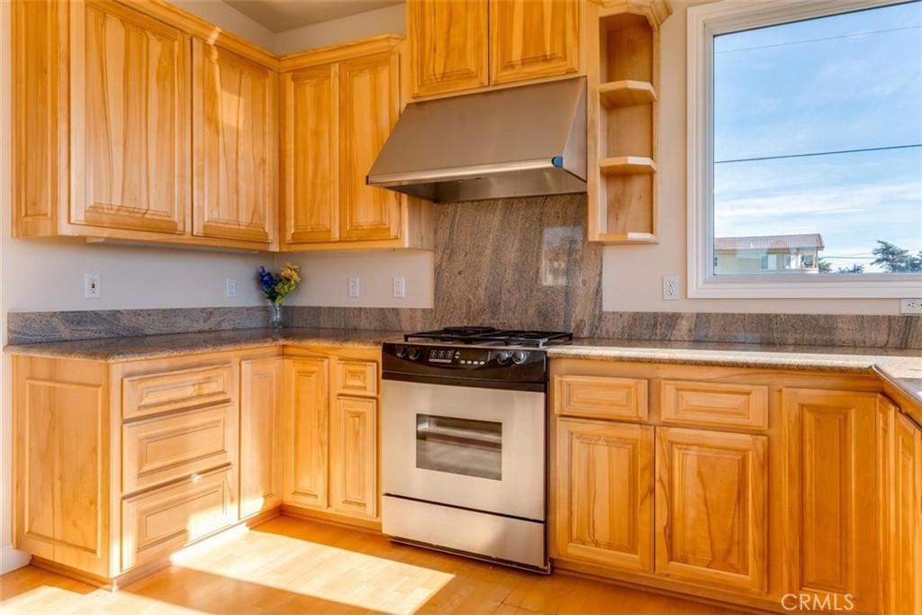 305 Ivar Street Cambria, CA 93428 - Photo 24 of 69 a kitchen with stainless steel appliances granite countertop a stove and a white cabinets