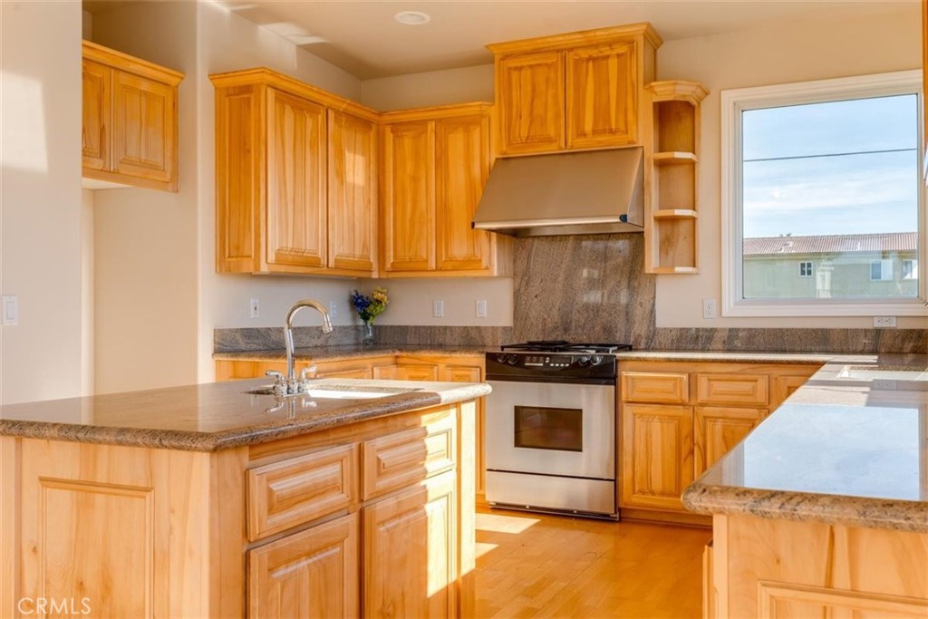 305 Ivar Street Cambria, CA 93428 - Photo 29 of 69 a kitchen with stainless steel appliances granite countertop a sink stove and refrigerator