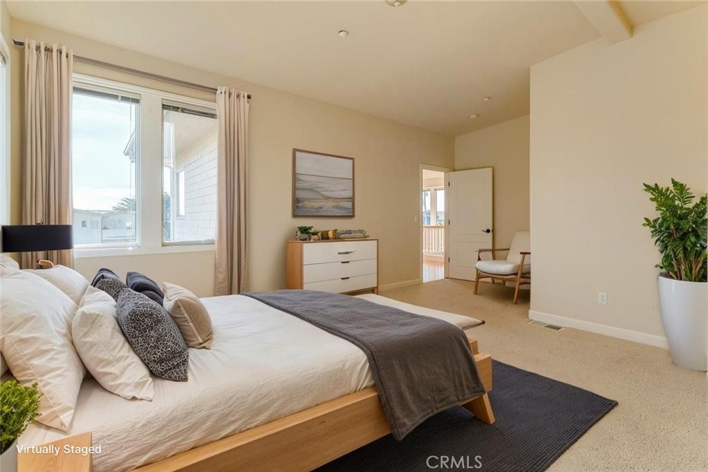 305 Ivar Street Cambria, CA 93428 - Photo 9 of 69 a bedroom with a bed and a potted plant