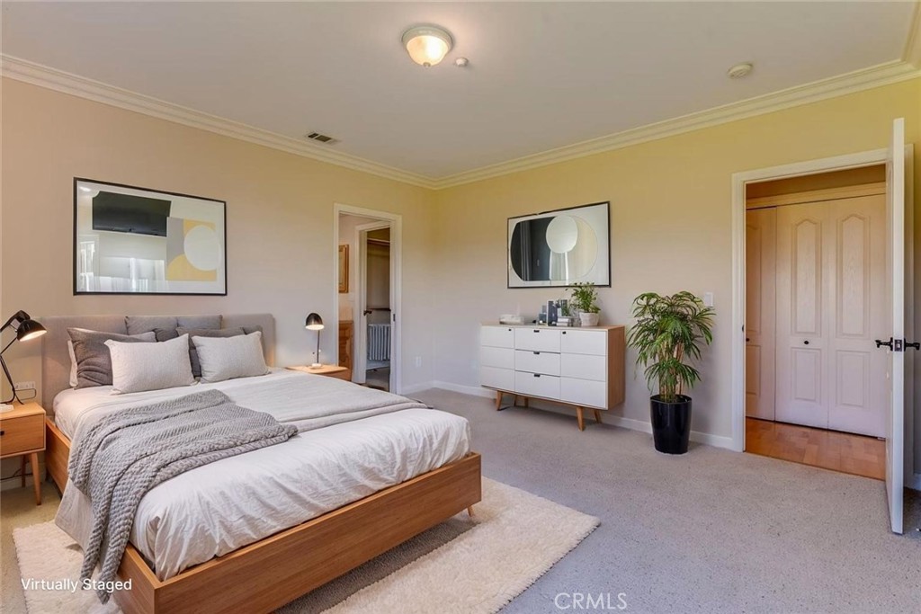 305 Ivar Street Cambria, CA 93428 - Photo 10 of 69 a spacious bedroom with a bed a couch and a potted plant