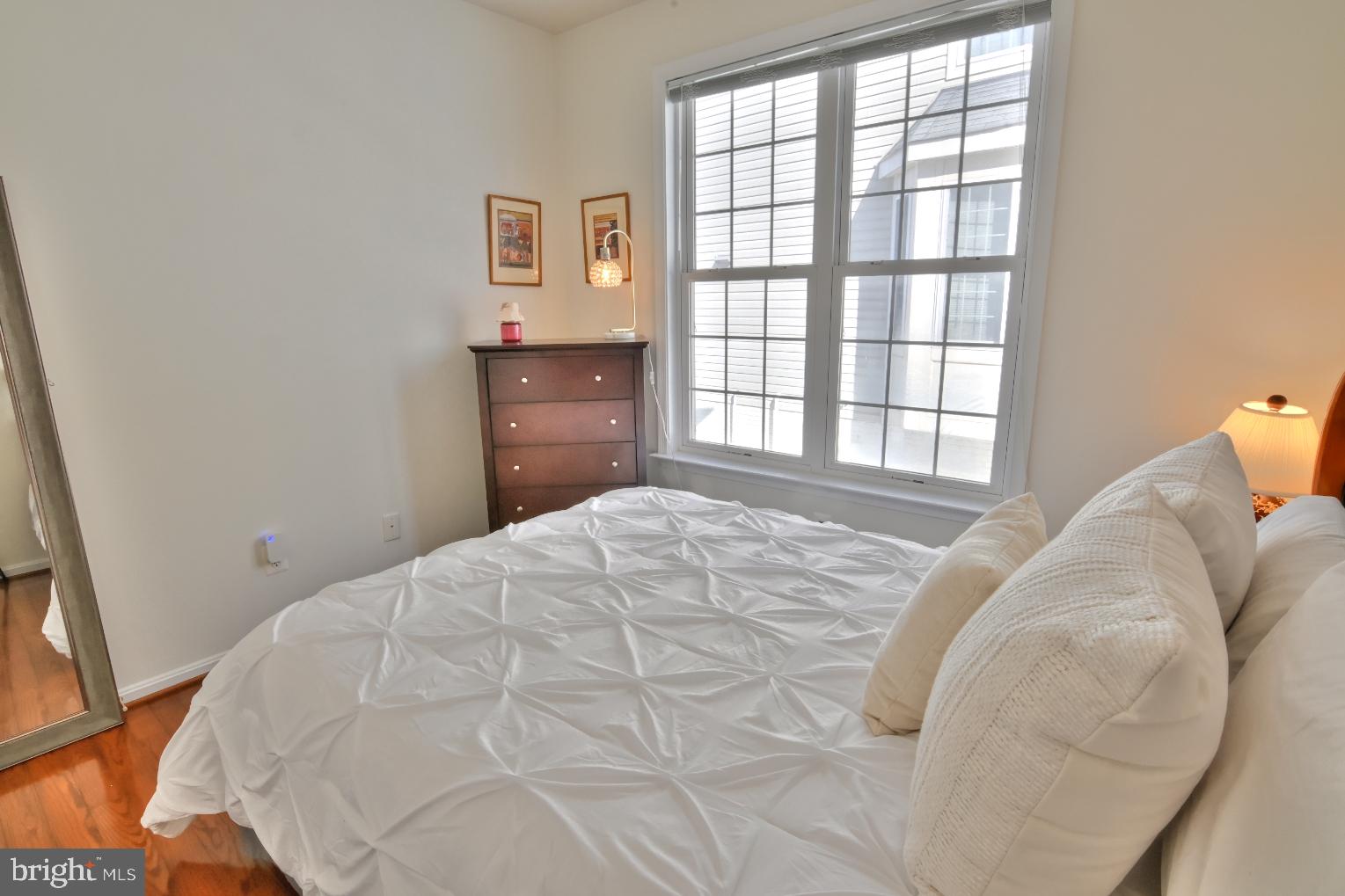 13170 Triple Crown Loop Gainesville, VA 20155 - Photo 40 of 71 a bedroom with a bed and wooden floor