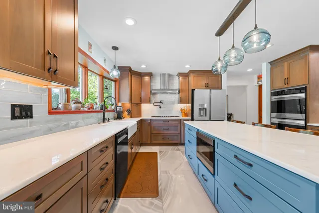 a large kitchen with stainless steel appliances granite countertop a lot of counter space and cabinets