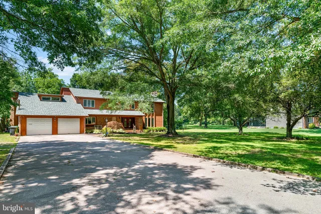 a living room with furniture a ceiling fan and a window