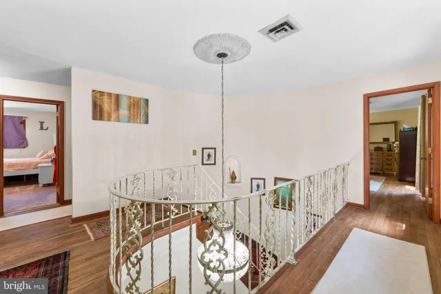 an aerial view of residential house with outdoor space and trees all around