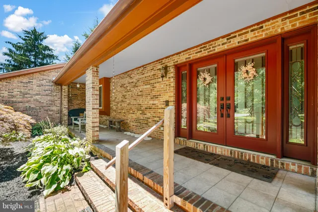 an aerial view of residential house with outdoor space and swimming pool