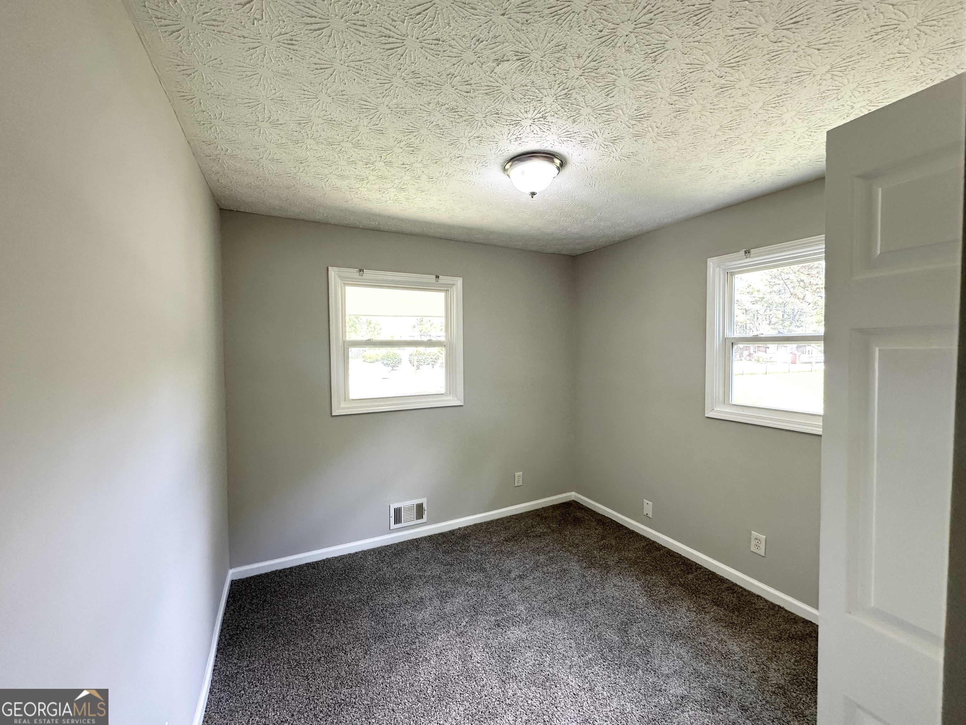 3798 Bakers Ferry Road Southwest Atlanta, GA 30331 - Photo 11 of 21 an empty room with a empty space and windows