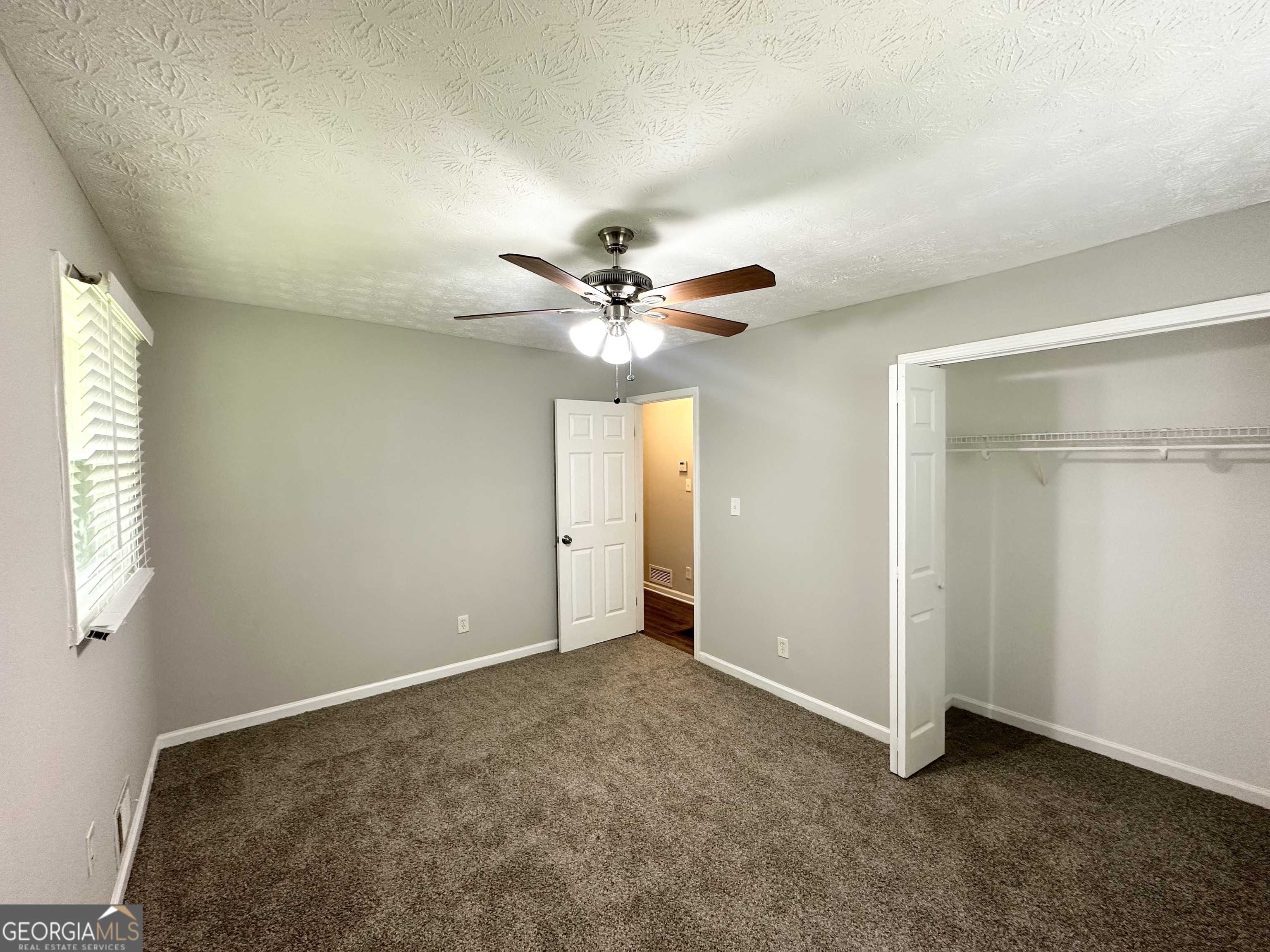 3798 Bakers Ferry Road Southwest Atlanta, GA 30331 - Photo 14 of 21 a view of an empty room with a ceiling fan