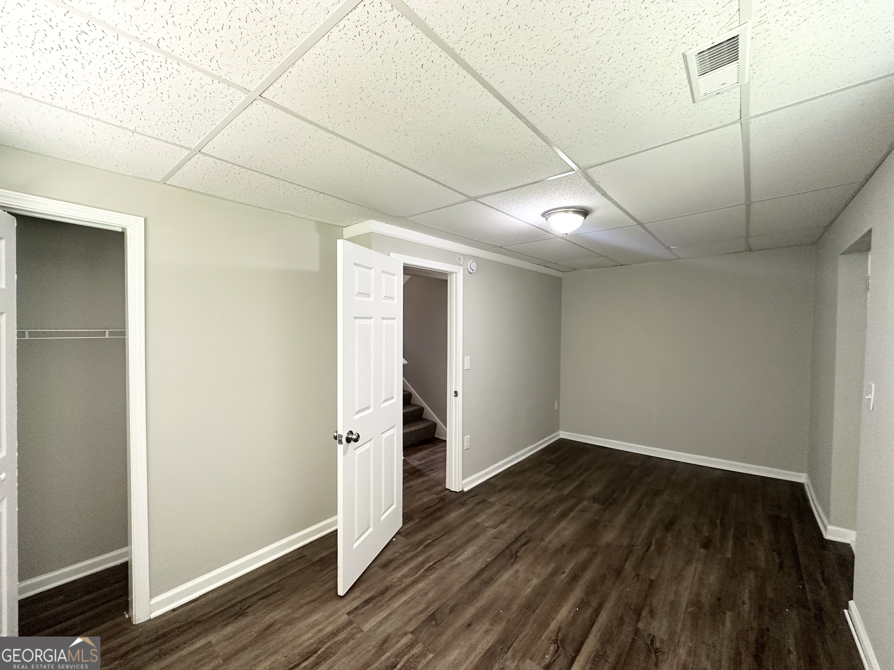 3798 Bakers Ferry Road Southwest Atlanta, GA 30331 - Photo 18 of 21 an empty room with wooden floor and windows