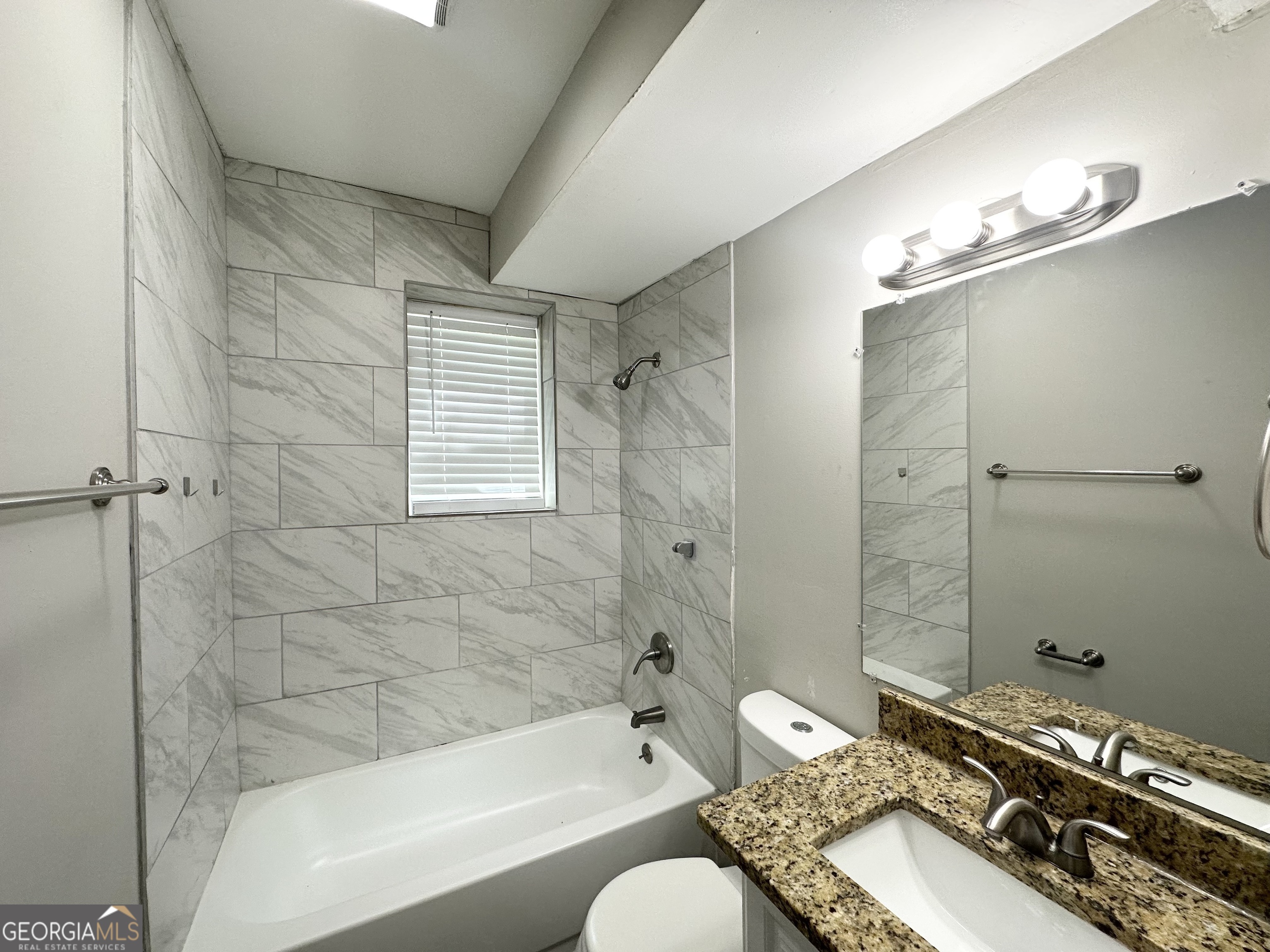 3798 Bakers Ferry Road Southwest Atlanta, GA 30331 - Photo 20 of 21 a bathroom with a granite countertop sink toilet a mirror and shower