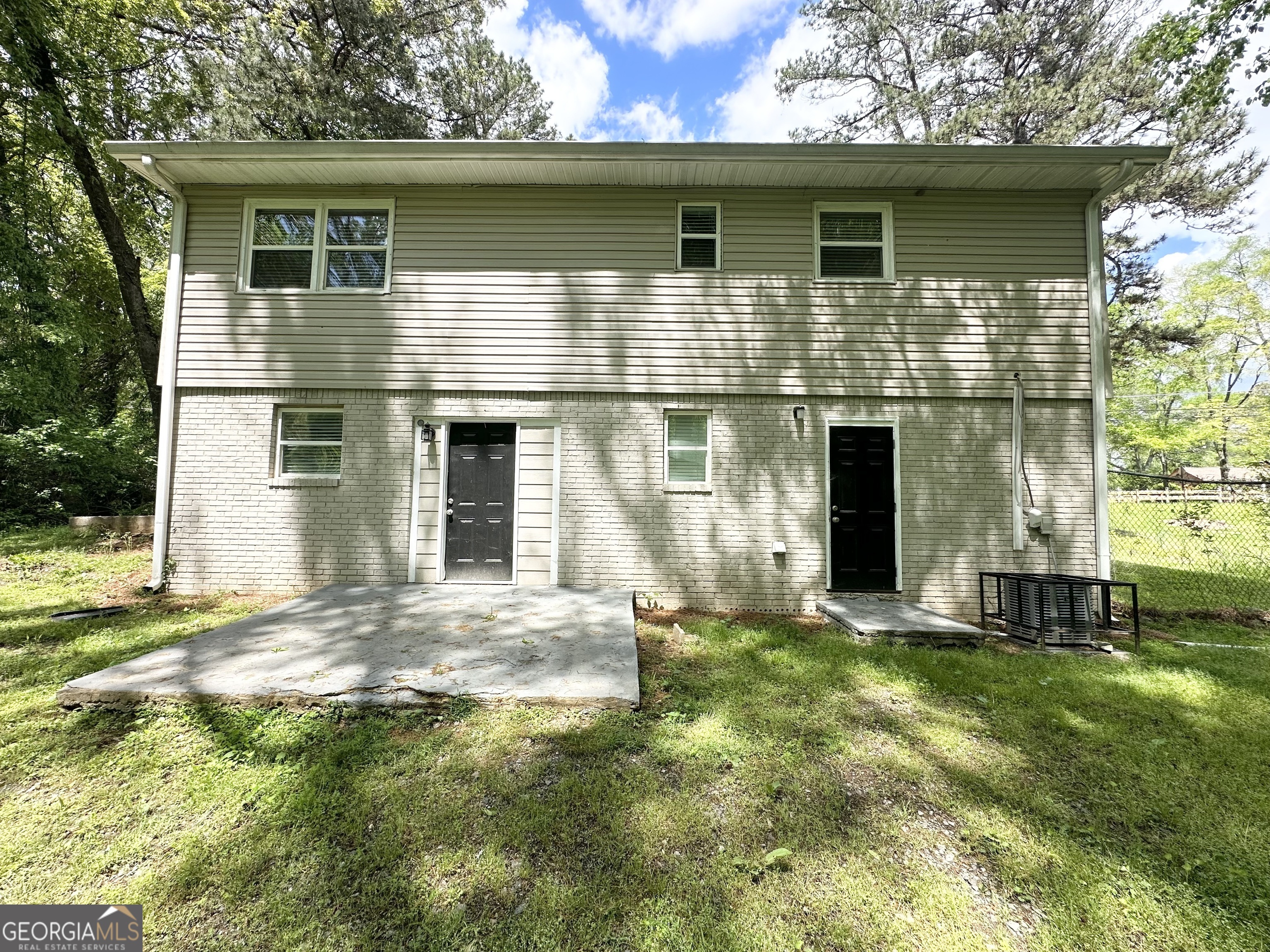 3798 Bakers Ferry Road Southwest Atlanta, GA 30331 - Photo 21 of 21 a front view of a house with a garden