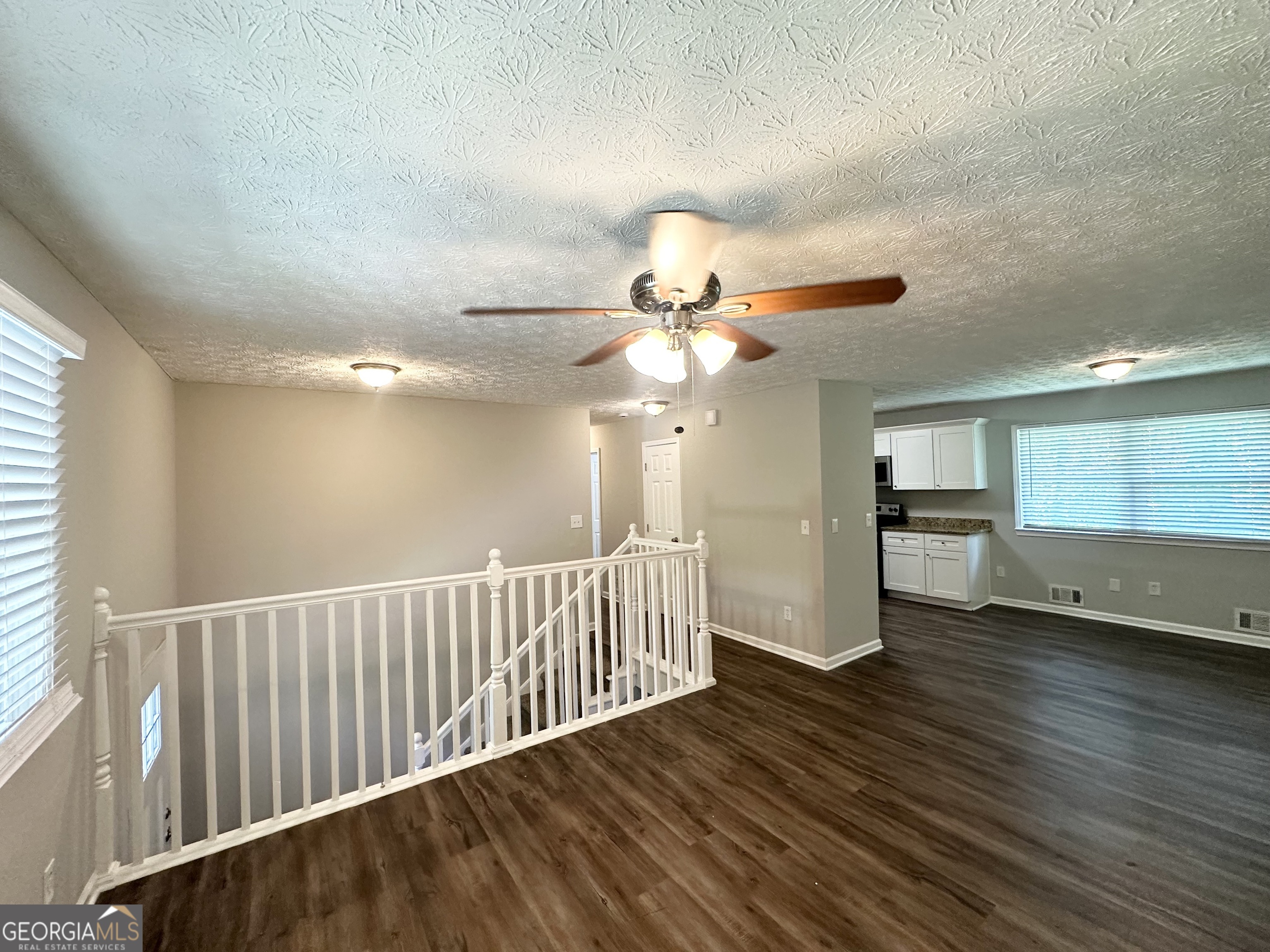 3798 Bakers Ferry Road Southwest Atlanta, GA 30331 - Photo 3 of 21 a view of an empty room with wooden floor and a window