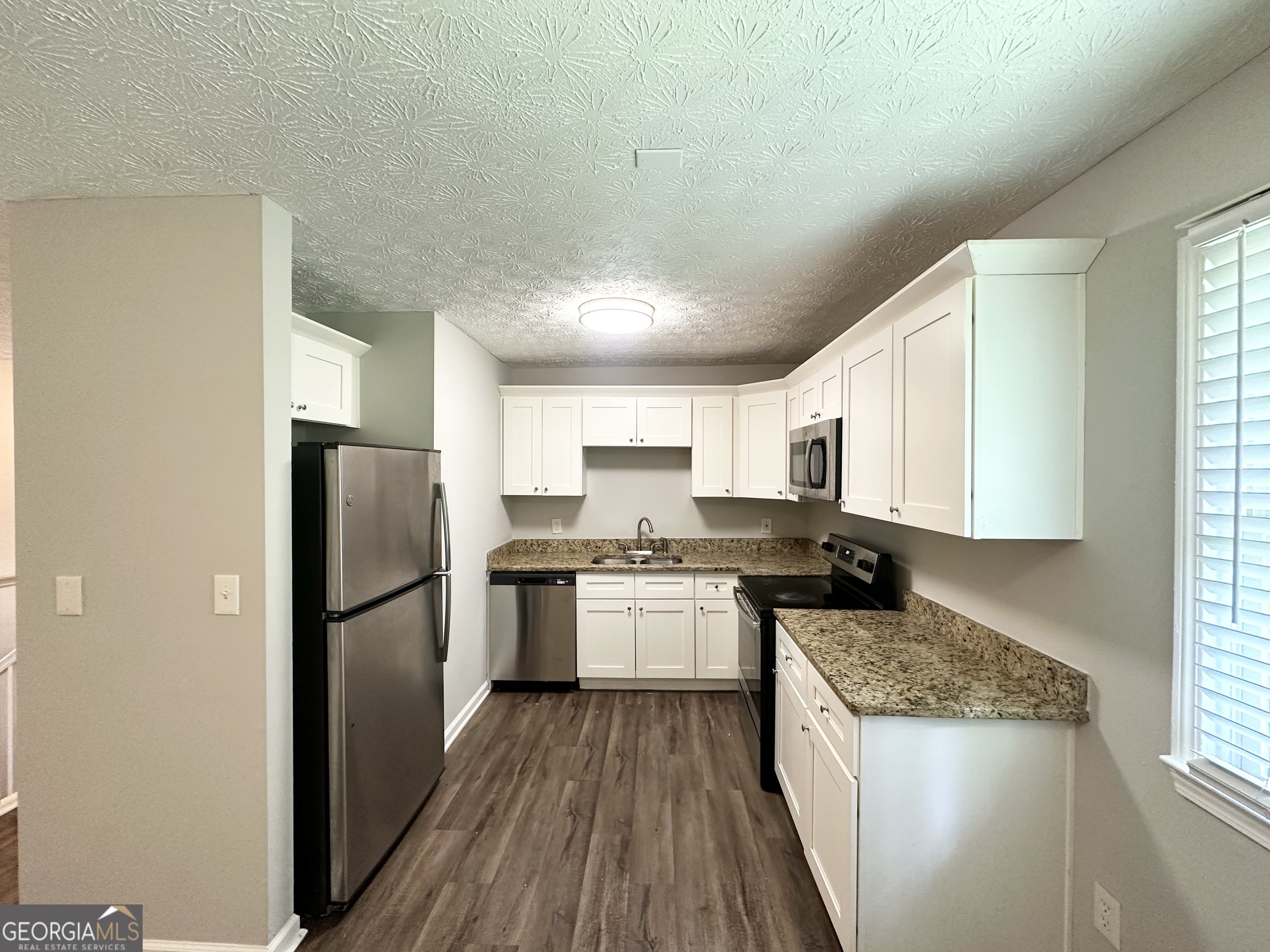 3798 Bakers Ferry Road Southwest Atlanta, GA 30331 - Photo 6 of 21 a kitchen with a stove a refrigerator and a sink