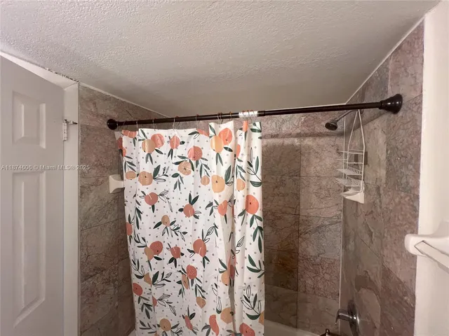 a bathroom with a shower curtain and a shower curtain