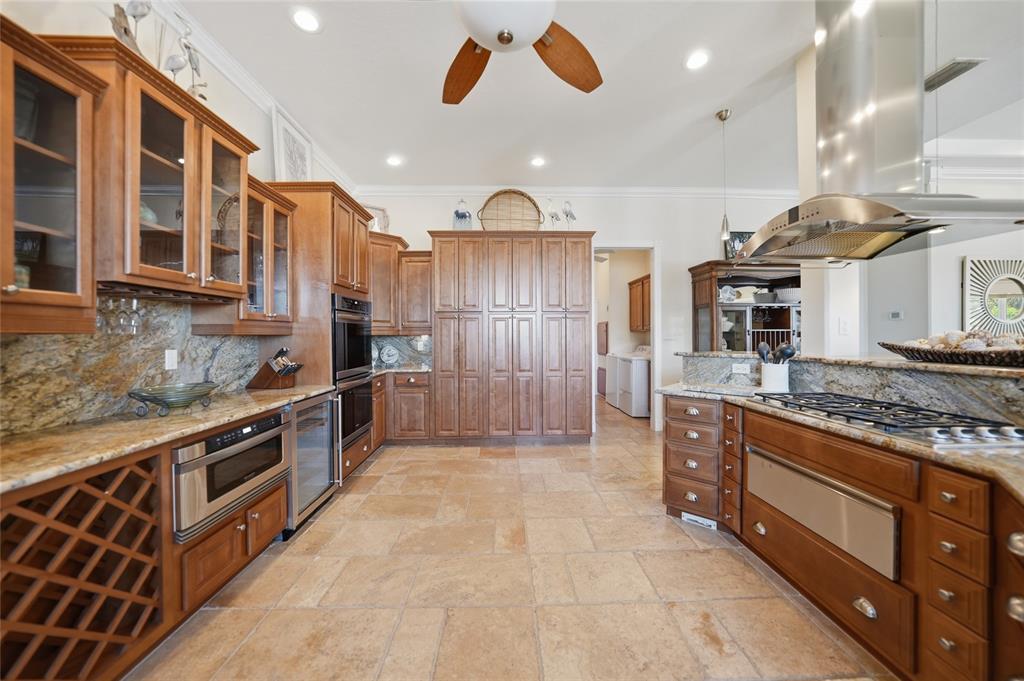 8635 Southwest Riverside Drive Arcadia, FL 34269 - Photo 14 of 70 a large kitchen with stainless steel appliances granite countertop a stove a sink and a refrigerator