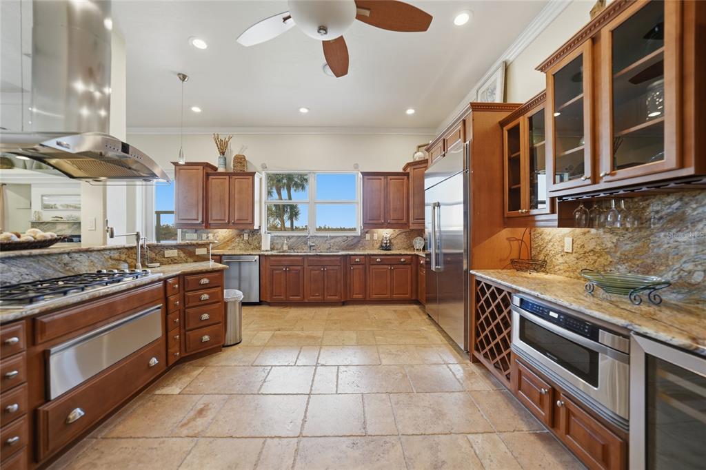 8635 Southwest Riverside Drive Arcadia, FL 34269 - Photo 15 of 70 a large kitchen with stainless steel appliances granite countertop a stove and a sink