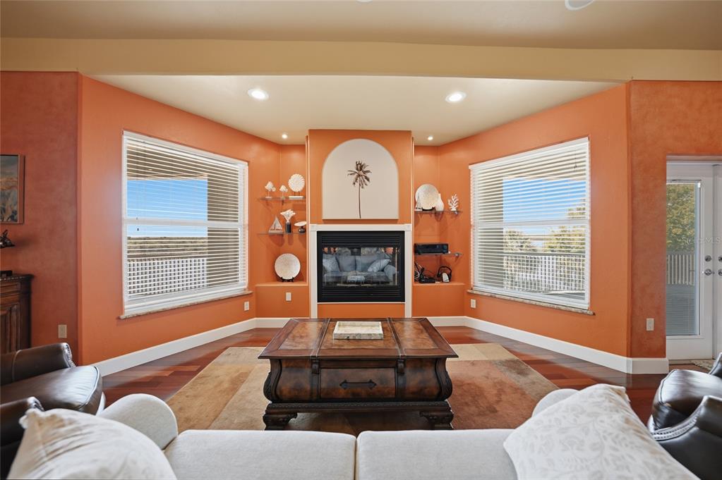 8635 Southwest Riverside Drive Arcadia, FL 34269 - Photo 22 of 70 a living room with furniture a fireplace and a large window