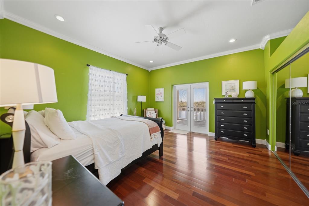 8635 Southwest Riverside Drive Arcadia, FL 34269 - Photo 27 of 70 a spacious bedroom with a bed and a dresser with wooden floor