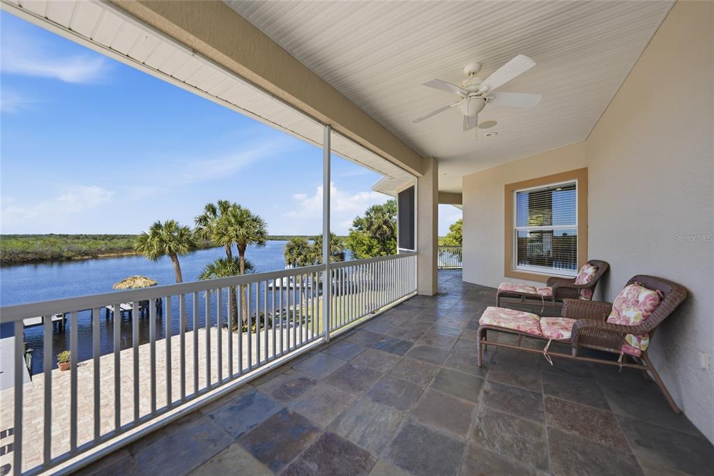 8635 Southwest Riverside Drive Arcadia, FL 34269 - Photo 34 of 70 a view of a porch with furniture and a floor to ceiling window