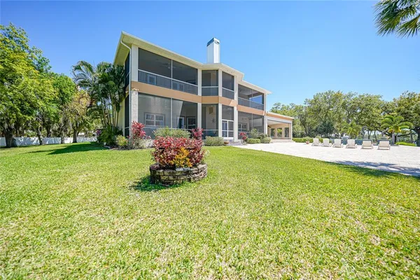 a view of a house with backyard and sitting area
