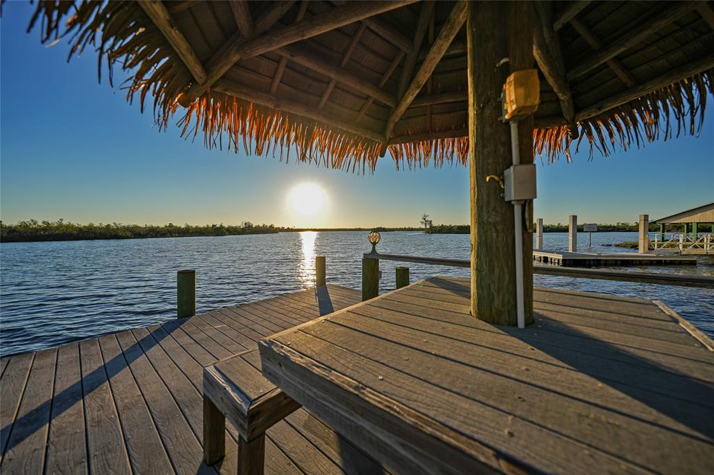 8635 Southwest Riverside Drive Arcadia, FL 34269 - Photo 60 of 70 a view of a balcony with wooden floor and outdoor seating
