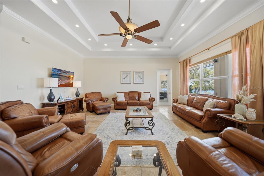 8635 Southwest Riverside Drive Arcadia, FL 34269 - Photo 8 of 70 a living room with furniture a large window and a ceiling fan