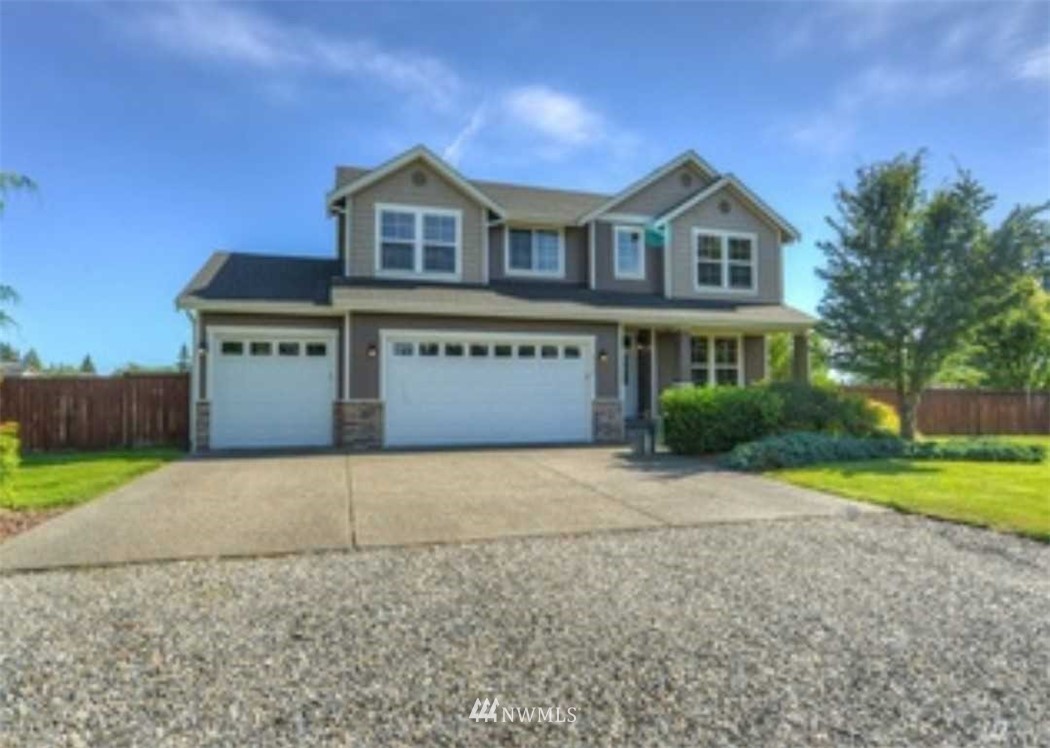 8239 178th Avenue Southwest Rochester, WA 98579 - Photo 1 of 1 a front view of a house with a yard and garage