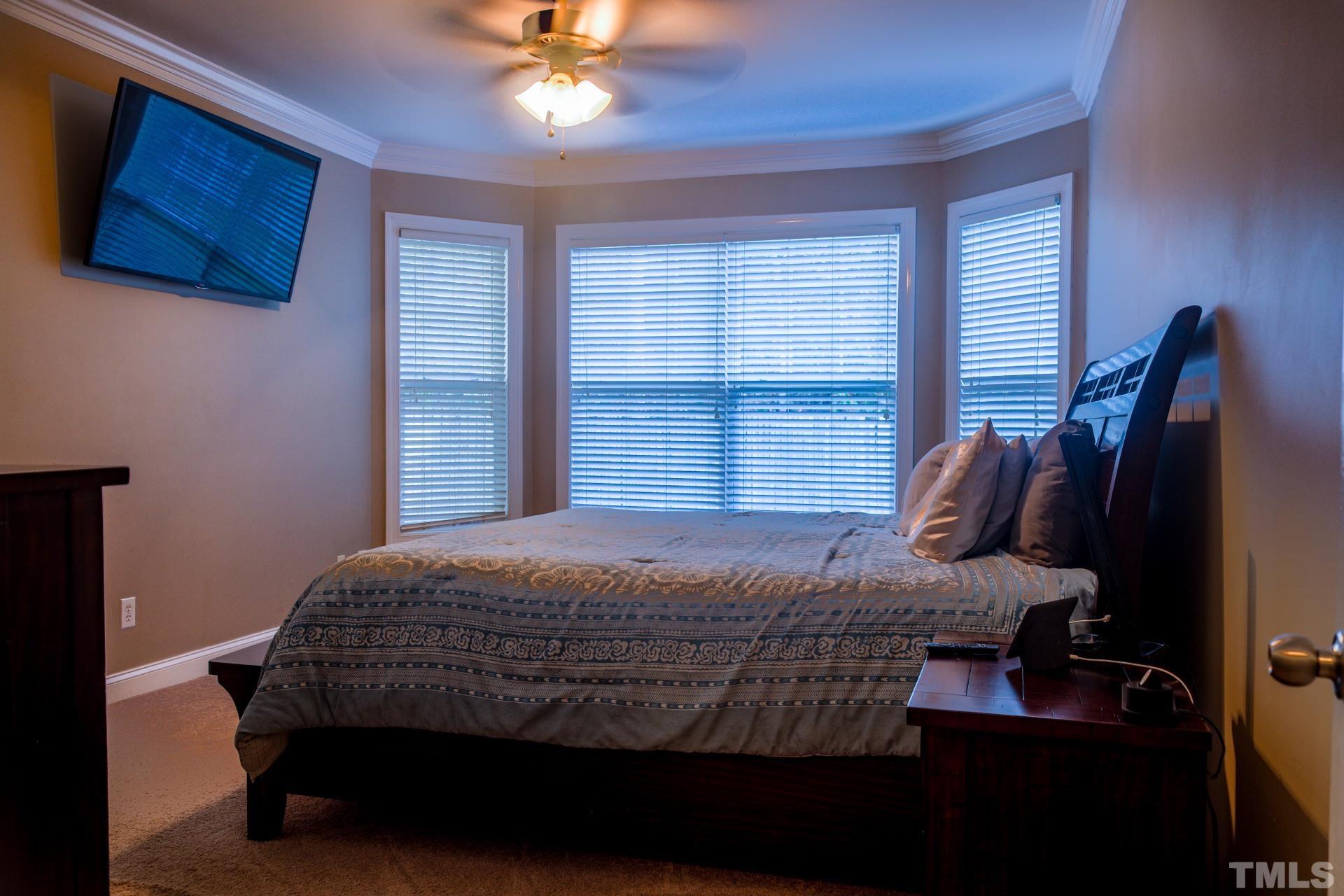 10100 Darling Street Raleigh, NC 27613 - Photo 12 of 24 a bedroom with a bed and chair